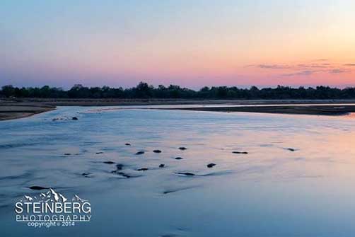 Having sundowners along the banks of the Luangwa River